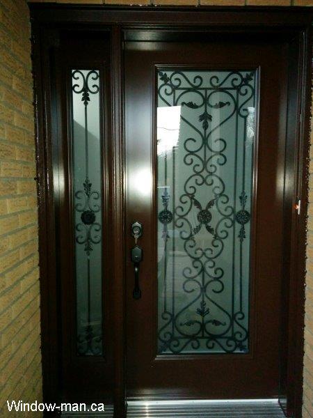Single entry insulated steel front door with one sidelight. Brown spray painting. Port Stanly iron glass inserts